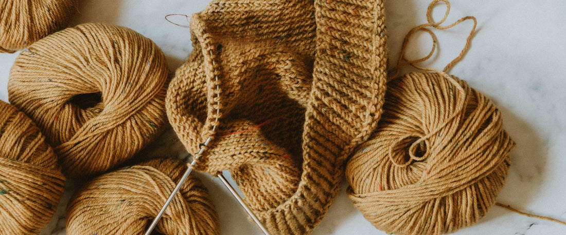 Yarn and a knitting project on marble