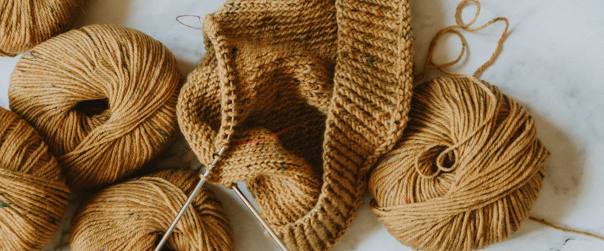 Yarn and a knitting project on marble